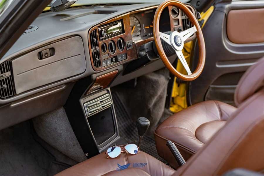 From the SAAB full leather interior to the sporty wooden steering wheel, every detail of this Lynx Yellow SAAB 900 Convertible exudes luxury.