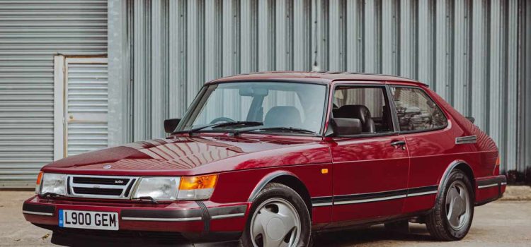 1993 Saab 900 Turbo Ruby Edition in pristine condition, showcasing its classic Ruby Red finish and distinctive three-spoke alloy wheels.