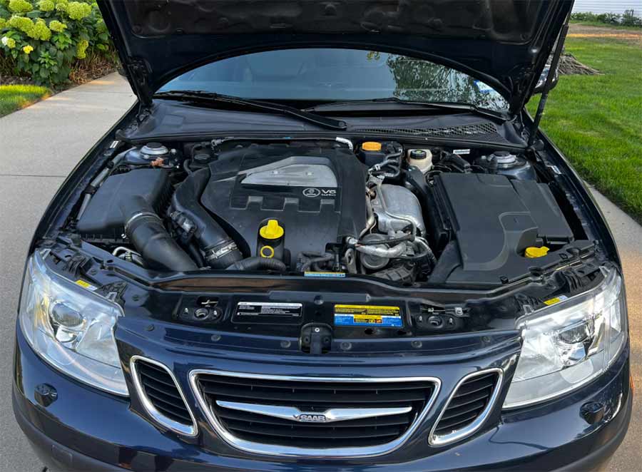 Engine bay of a 2007 Saab 9-3 Aero Convertible showing the 2.8-liter turbocharged V6 with factory covers and components.
