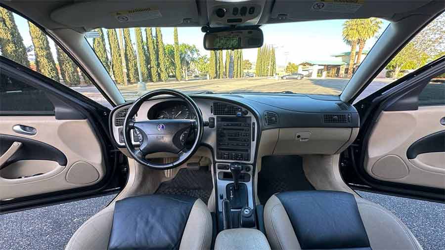 A cockpit designed for drivers—this 2004 Saab 9-5 Aero features a rare two-tone leather interior, paddle shifters, and Saab’s signature center-console ignition.