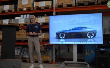 Frank Smit presenting the potential Sonett revival project, showcasing a sleek modern coupe design on screen.