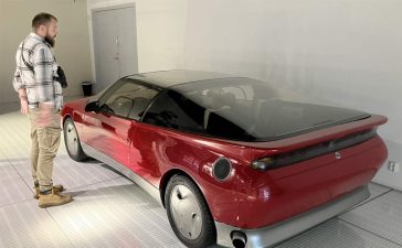 Milija Šćepanović next to a Saab concept model inside the Saab Car Museum during the 50th anniversary Night at the Saab Museum event