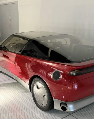 Milija Šćepanović next to a Saab concept model inside the Saab Car Museum during the 50th anniversary Night at the Saab Museum event