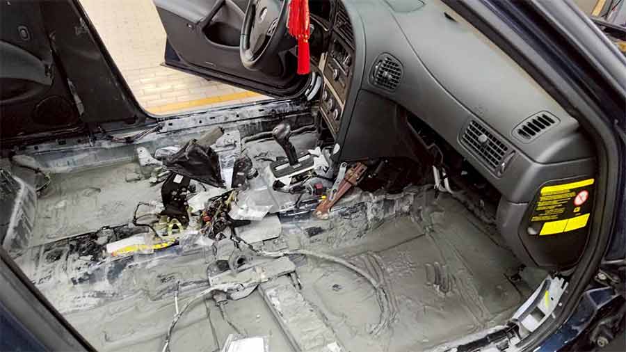 The Saab 9-5’s cabin after the seats were removed, revealing several centimeters of compacted mud left by the Guangfu flood.