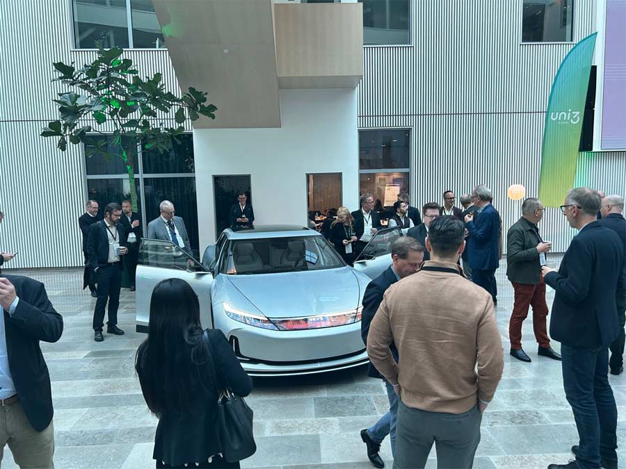 Enthusiastic attendees from Scandinavian automotive supplier firms get a firsthand look at the NEVS EMILY GT prototype, generating excitement and anticipation at SLD2023.