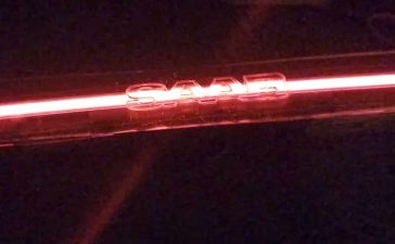 Prototype Saab 9-3 SportCombi LED bar glowing in signature red with illuminated SAAB lettering — a modern continuation of Saab’s design legacy by KM-Tronics.