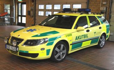 Saab 9-5: From Law Enforcement to Lifesaver – A captivating transformation captured as the Saab 9-5 dons its vibrant 'Ambulance Yellow' livery, transitioning from a specialized police cruiser to a life-saving medical vehicle.