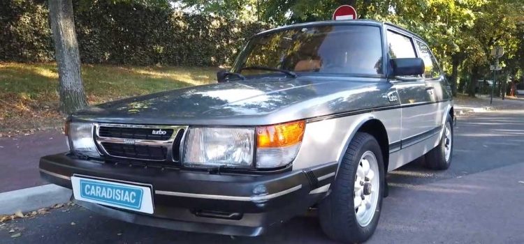 Under the spotlight: A gleaming 1984 Saab 900 Turbo, meticulously restored to its original splendor, symbolizes the timeless allure of Swedish engineering and passion for automotive heritage.