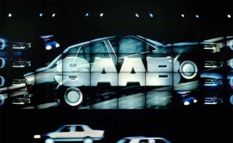 A dazzling Saab 9000 CD 1987 promotion, with two vehicles poised before a towering 26-foot-tall projection screen.