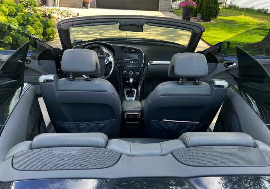 The two-tone leather interior of the 2007 Saab 9-3 Aero Convertible — driver-focused ergonomics and a perfectly preserved cabin after 29,000 miles.