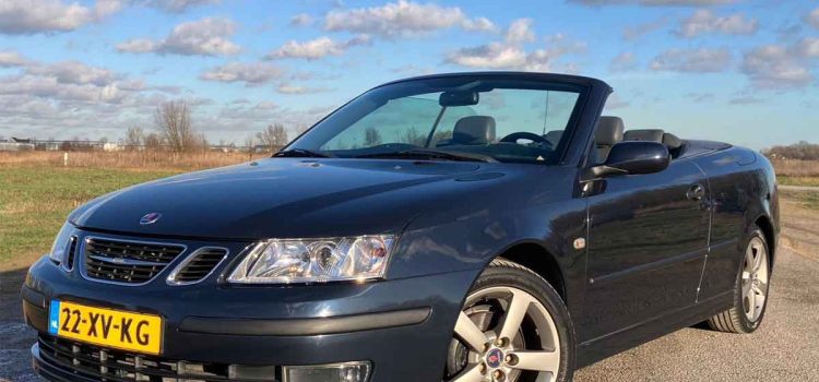 The Ultimate Summer Car: Saab 9-3 Convertible - A Blend of Performance and Luxury 8 A sleek blue Saab 9-3 Vector Cabriolet with the top down, showcasing its sporty alloy wheels and two-tone leather interior, parked under a clear sky.
