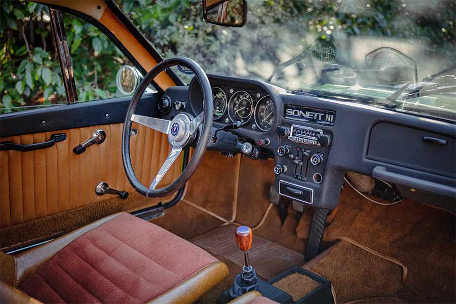 Step inside the vintage charm of the 1970 SAAB Sonett III's cabin, featuring a minimalist yet functional design, perfect for an immersive driving experience. 