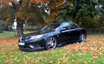 How One Owner Turns a Saab 9-3 Turbo X Into a 280 hp Driver’s Machine 6 Lowered Saab 9-3 Turbo X parked on autumn leaves with upgraded wheels and a black exterior.