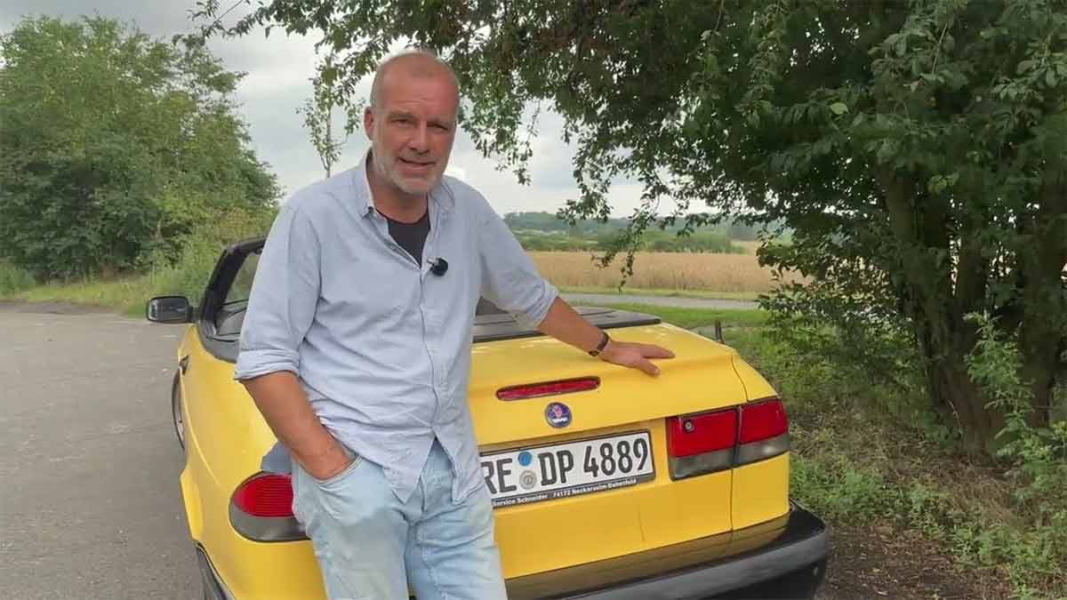 A Summer Car You’ll Actually Drive: Saab 9-3 Convertible, As Seen by a No-Nonsense Enthusiast 1 German automotive enthusiast standing beside a yellow Saab 9-3 Convertible during a summer review