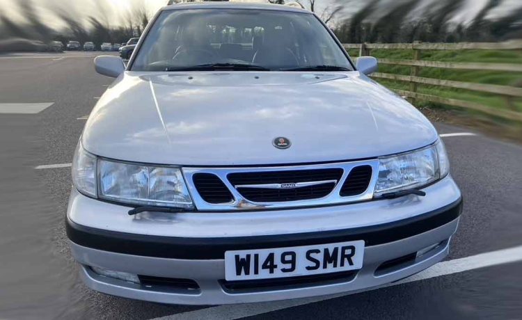 An immaculate Saab 9-5 SportCombi in pristine condition, gleaming under the sun with its ceramic-coated finish, ready to captivate the hearts of automotive enthusiasts and collectors alike.
