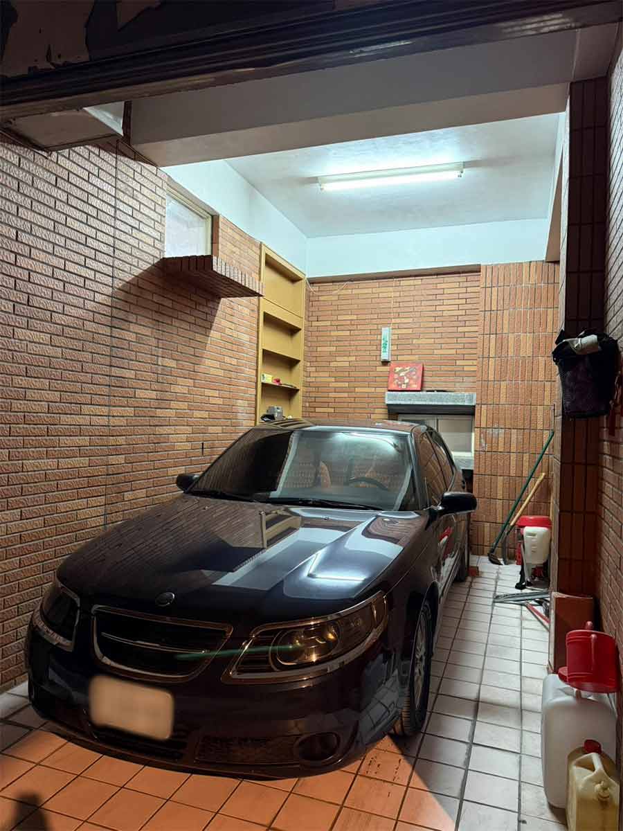 The restored Saab 9-5 parked safely in the Wu family’s garage after being recovered and rebuilt following the Guangfu flood.