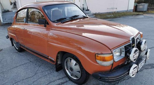 Vintage 1979 Saab 96 GL V4 Super in brown, showcasing its classic design and rally-ready enhancements, complete with auxiliary lights and distinctive rims.