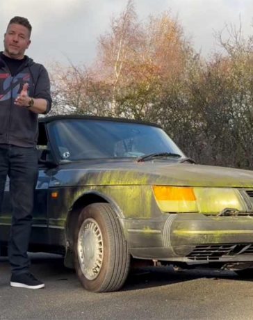 Paul Cowland standing beside his moss-covered Saab 900 Cabriolet, preparing to revive the long-parked classic.