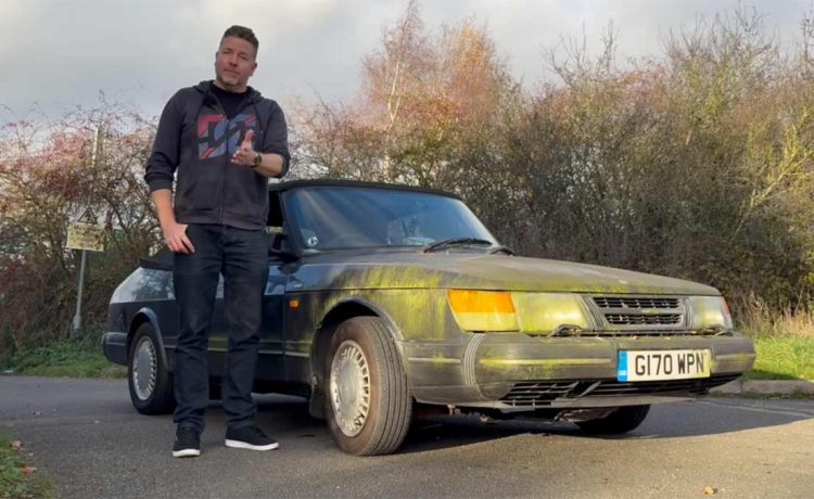 Paul Cowland standing beside his moss-covered Saab 900 Cabriolet, preparing to revive the long-parked classic.