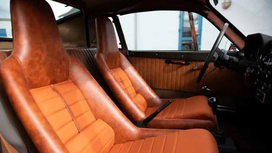 The timeless interior of the Saab Sonett III showcases vintage charm and period-correct details, providing a nostalgic driving experience. From the classic steering wheel to the elegant dark beige upholstery, every element reflects the Sonett's 1960s sporting heritage